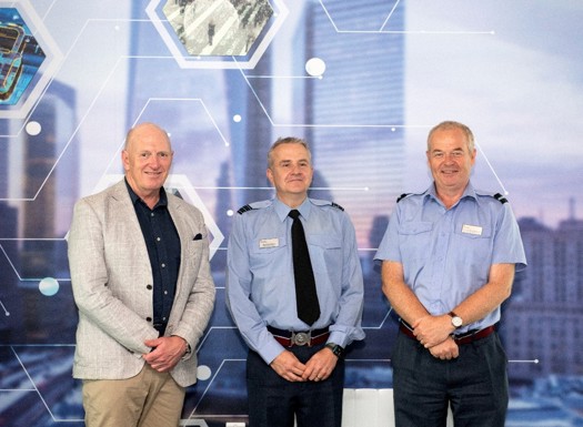 Australian Defence Force, Chief of Joint Capabilities, Lt Gen JJ Frewen and Deputy Commandant of the Defence Academy UK, Air Cmdre Hamish Cormack stood in front of a cyber banner.
