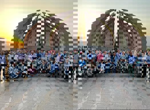 Course members stood in front of an impressive landmark in Pakistan