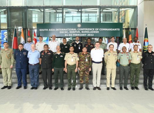 International delegates stood outside the Defence Services Command and Staff College, Bangladesh surrounded by national flags of those in attendance. 