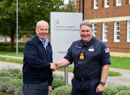 An RAF and Navy officer shaking hands.