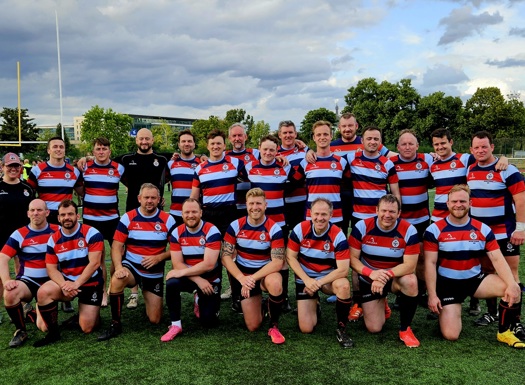 The Defence Academy rugby team in uniform on the pitch.