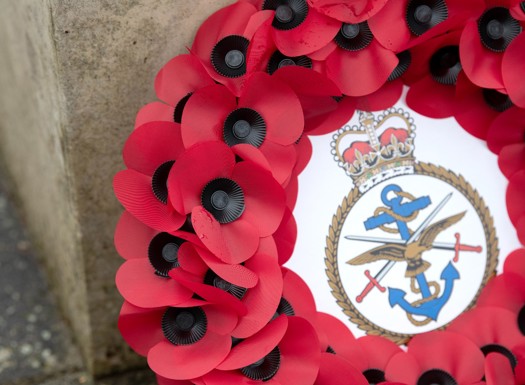Close up of poppy wreath with Defence Academy crest in the centre.