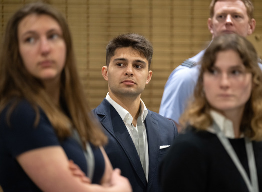 Men and women in suits and smart wear.
