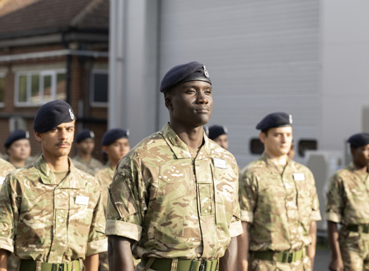 Pre-RMAS international students saluting during parade.