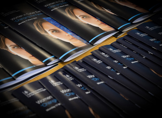 A row of 'Women in Cyber' leaflets overlapping.