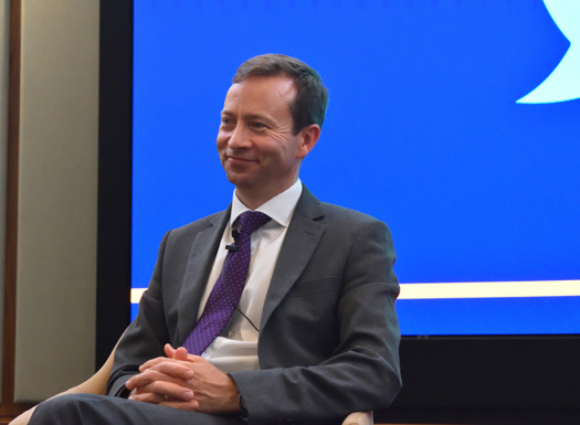 A panel of speakers sat in front of an audience.