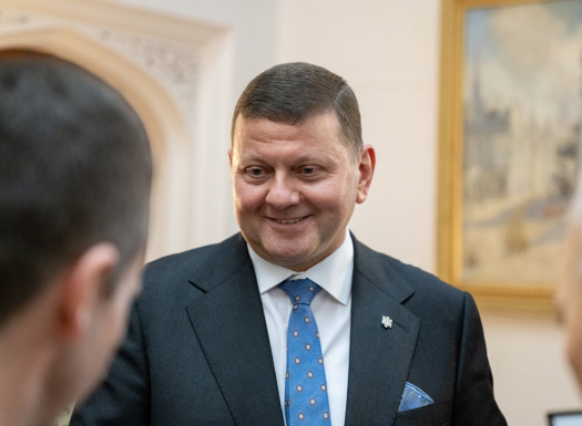 Ukrainian ambassador in suit smiling.