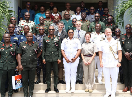 International military officers stood in a group shot in their uniforms.