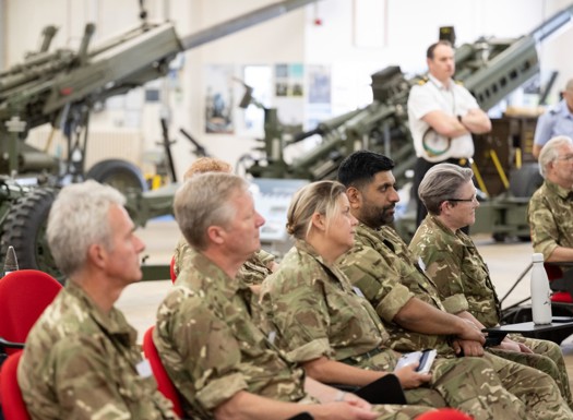 A group of AFPS members sat in a row listening to a talk.