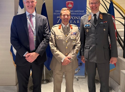 Swedish, British and Finish military officers stood at a NATO conference.