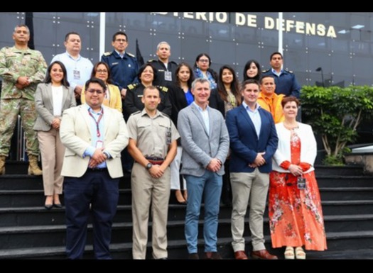 A group of BUIK and course trainers stood on steps outside Peruvian defence staff college. 