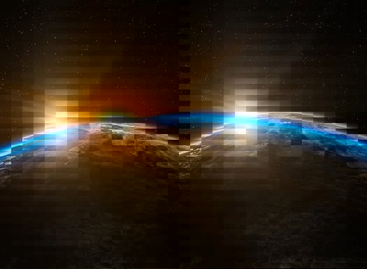 A view of earth from space with the sun being eclipsed in the background.