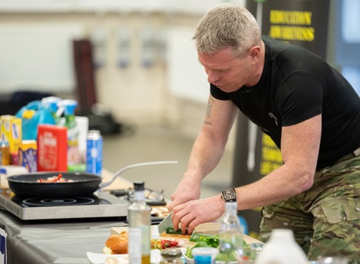 Commando chef cooking inside a hall.