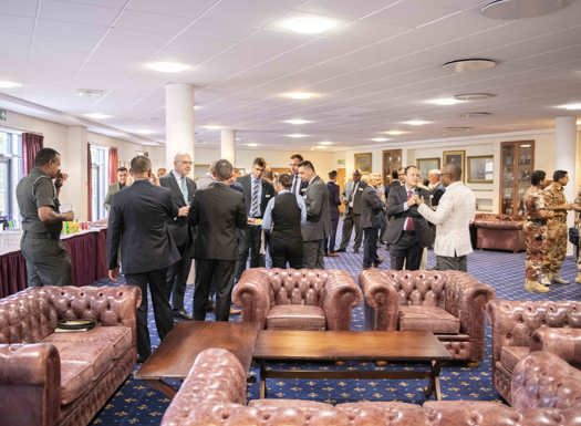 SSLP delegates sat in leather chairs conversing.