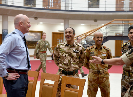 A group of Omani officers talking with an RAF officer. 